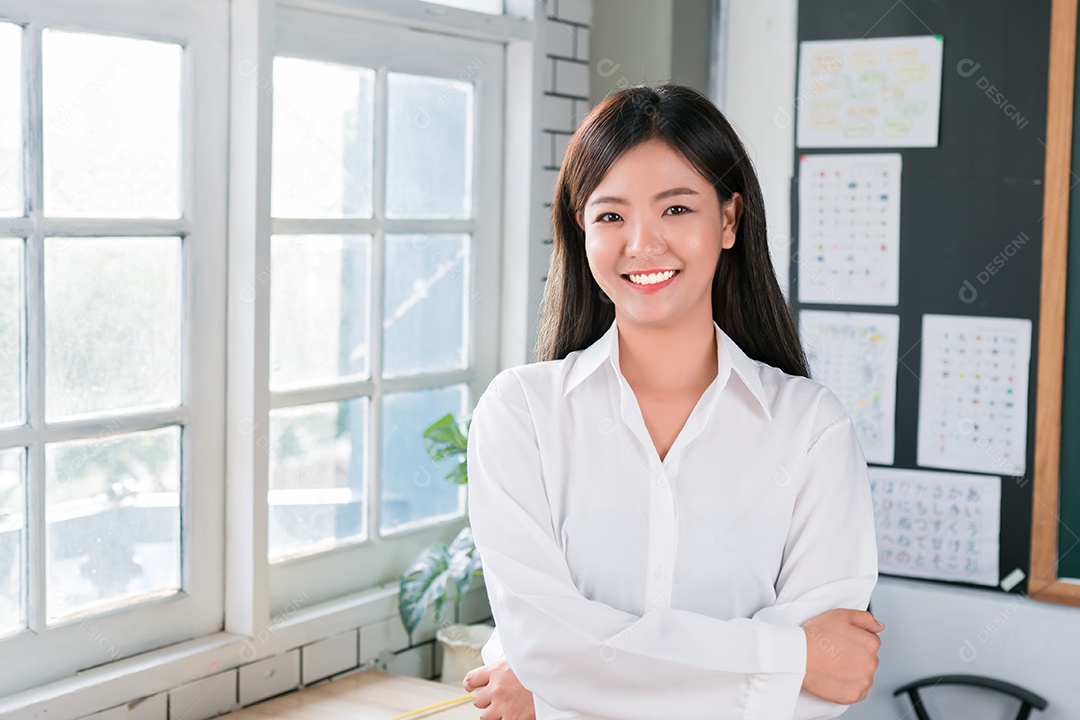 Empresária asiática atraente sorrindo confiança em pé e olhando para a câmera no escritório.
