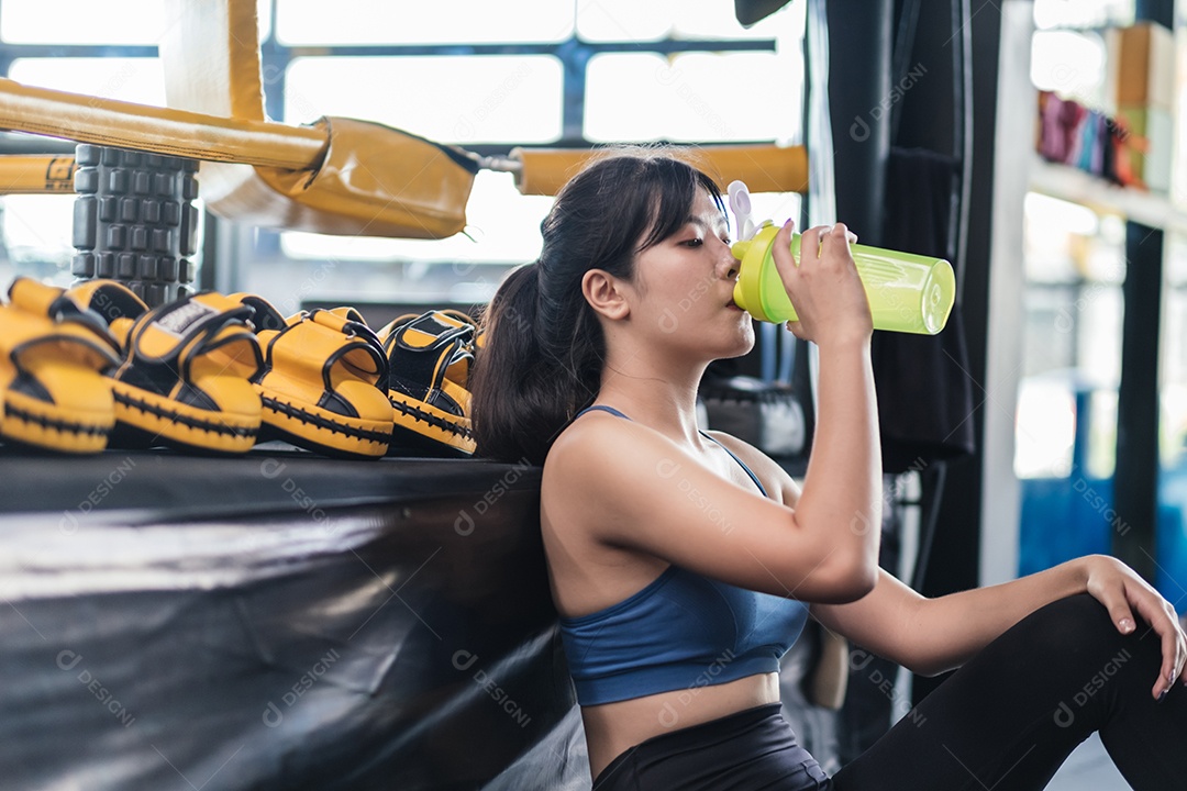 Jovem asiática após treino bem-sucedido na academia