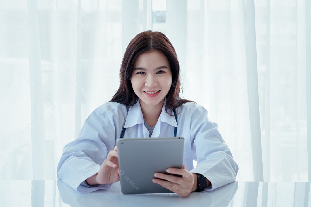 Mulher médica usando estetoscópio trabalhando com computador portátil na clínica