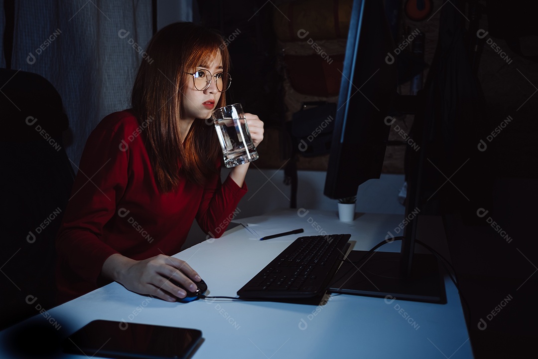 Mulher coreana trabalhando até tarde com computador