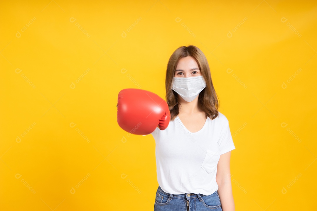 Jovem mulher asiática com proteção de máscara médica coronavírus COVID-19 lutando usando luvas de boxe conceito de cuidados