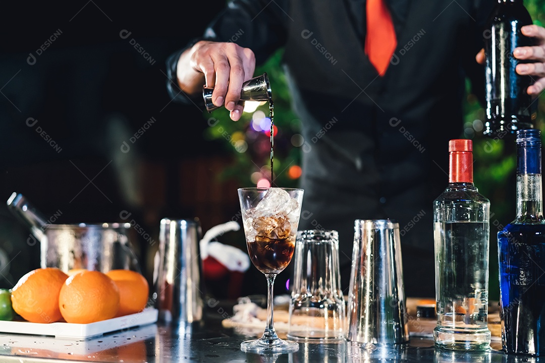 O barman profissional prepara uma bebida de coquetel na celebração da festa