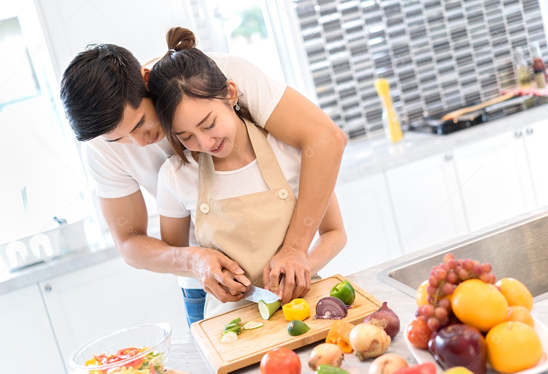 Casal cozinhando comida na cozinha fazendo jantar