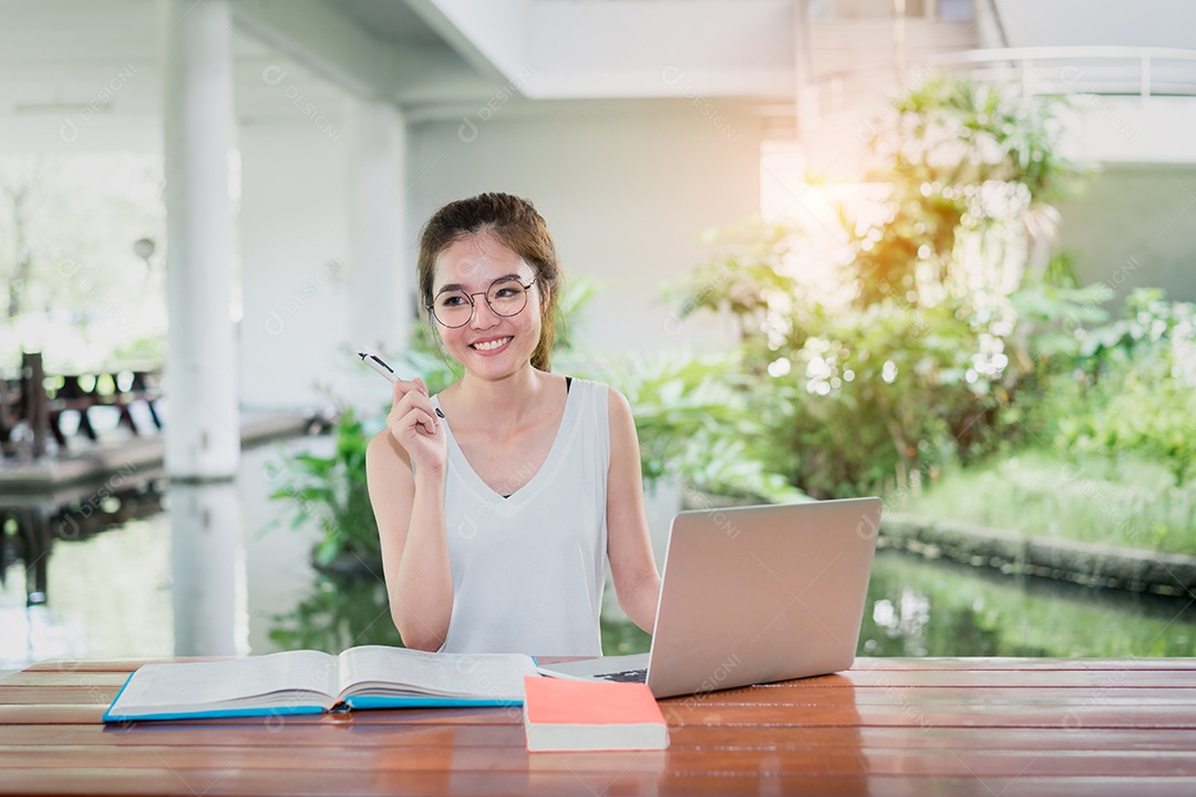 Jovem estudante com computador portátil feliz e divertido