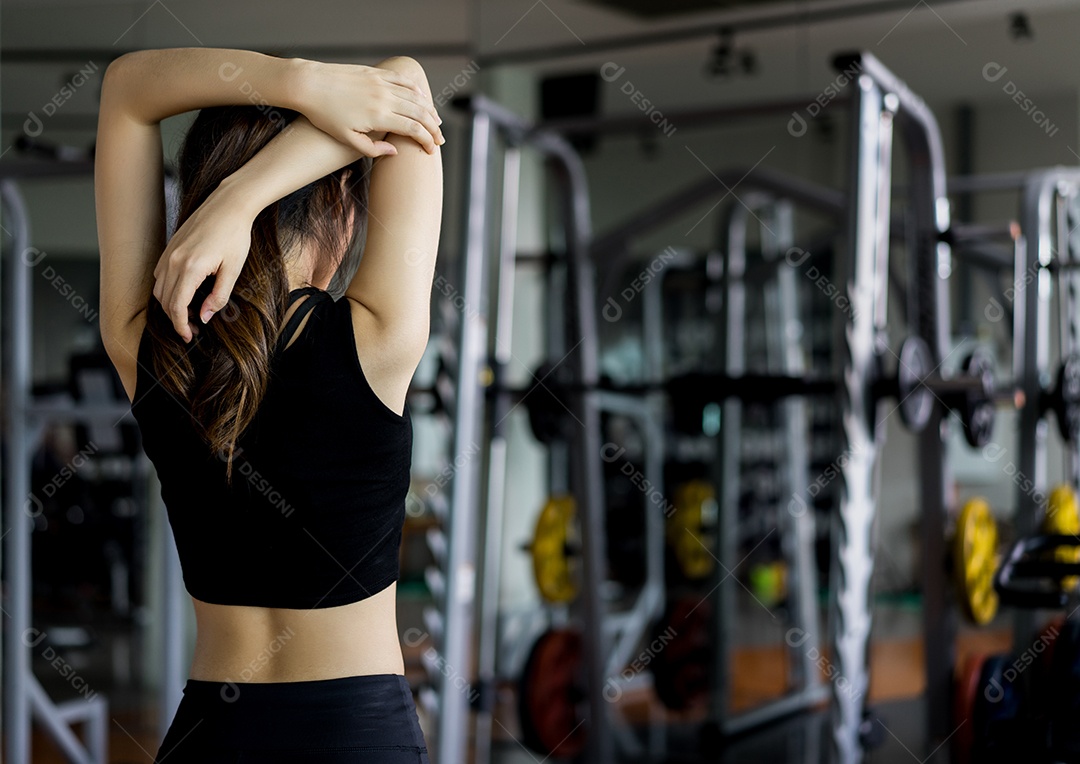 A mulher desportiva estica os músculos após o exercício