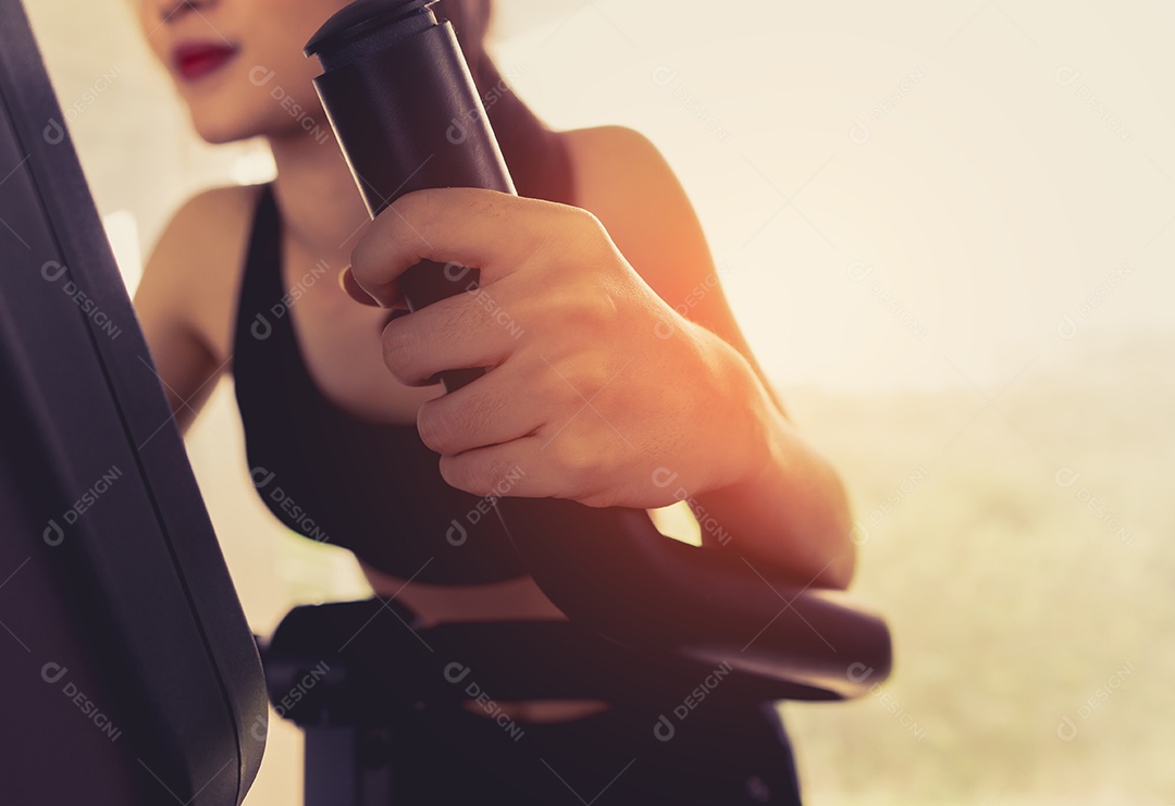 Treino da mulher na bicicleta ergométrica na academia fitness