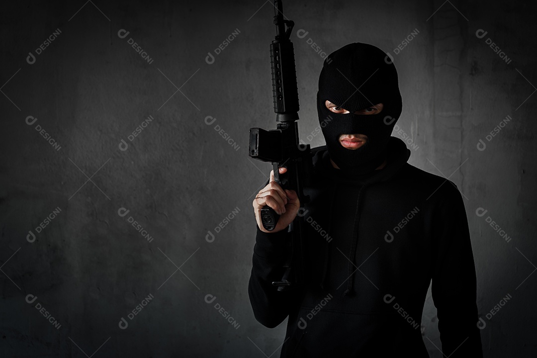 Ladrão ou terrorista com arma e mascarado para ataque com rifle de assalto