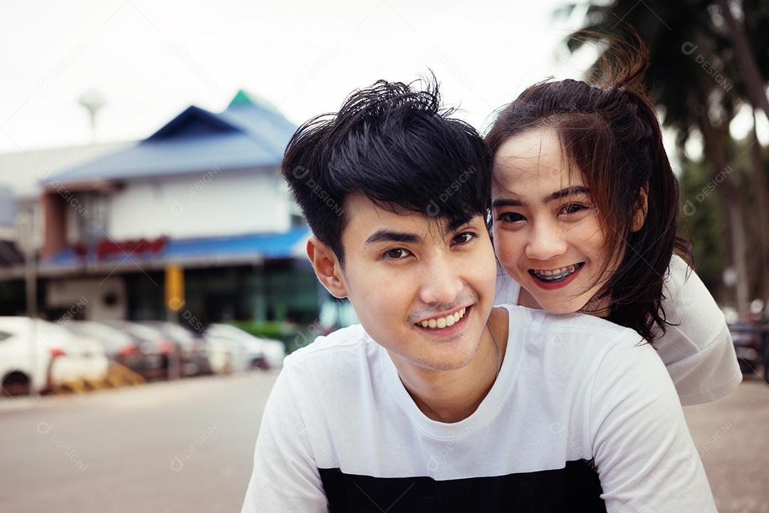 Casal abraçando e sorrindo felicidade ao ar livre