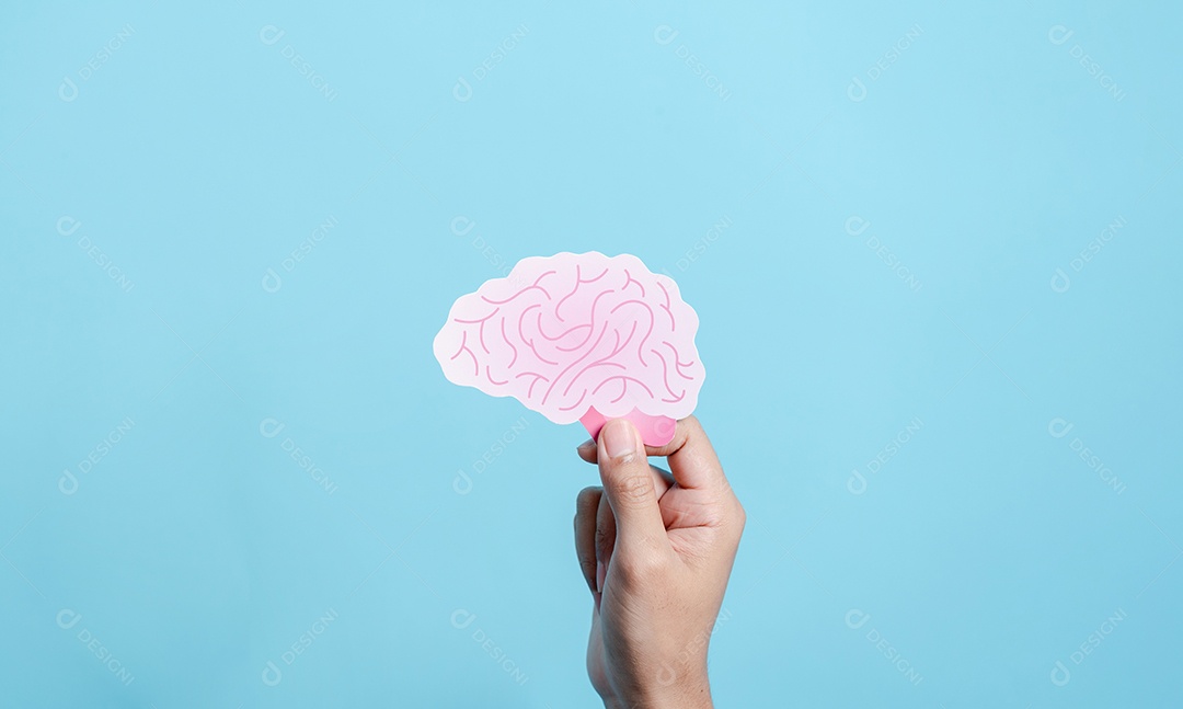 Mão segurando o corte de papel do cérebro humano