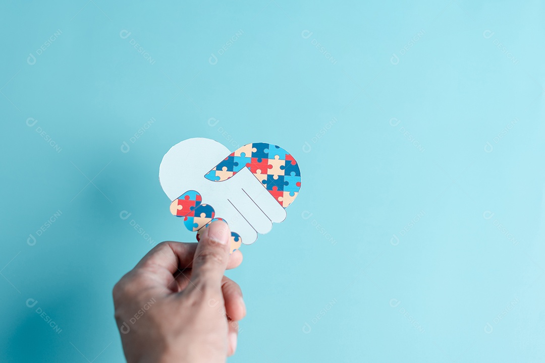 Papel de símbolo de quebra-cabeça de mão cortado de conscientização para apoio à família de transtorno do espectro do autismo.