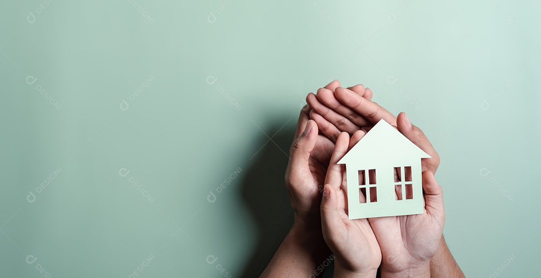 Mãos segurando uma casa de madeira, casa de família