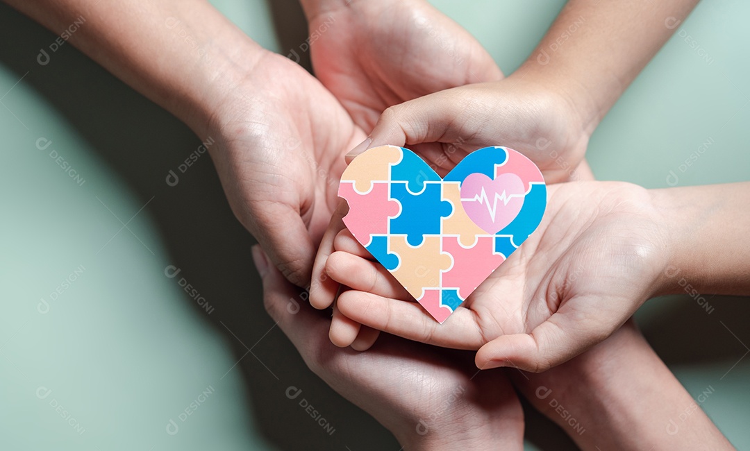 Pai, mãe, crianças segurando quebra-cabeças de coração apoio familiar ao transtorno do espectro autista.