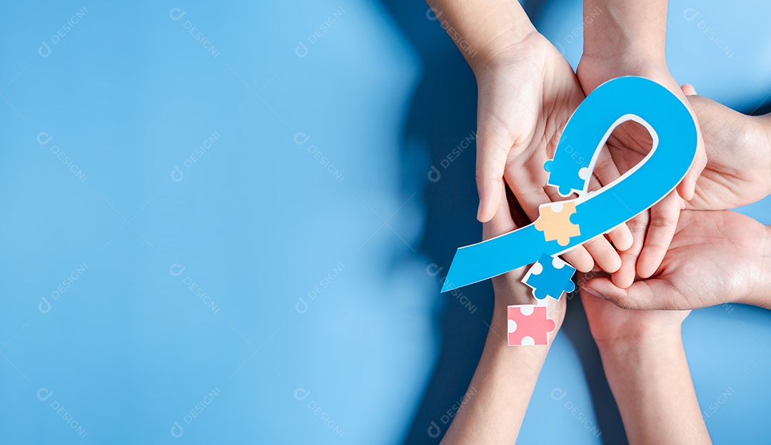 Pai, mãe, crianças segurando quebra-cabeça de fita Dia Mundial da Conscientização do Autismo.