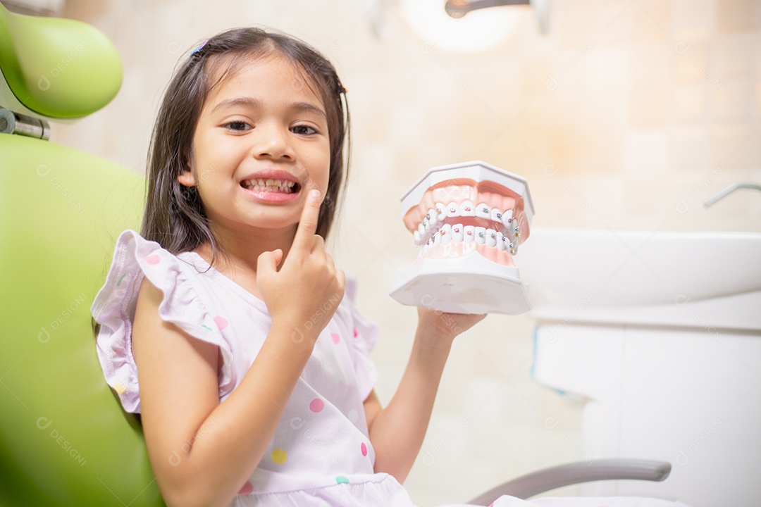 Os dentes das meninas asiáticas são saudáveis ​​no consultório odontológico.