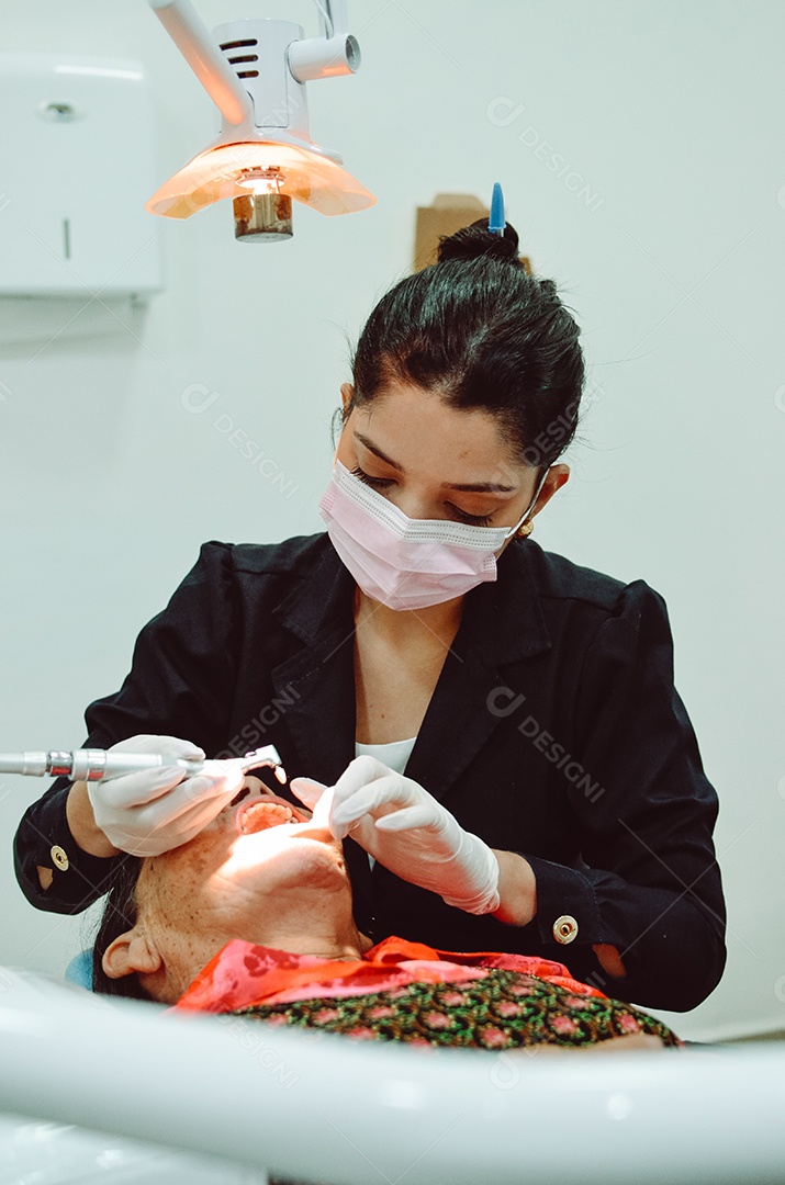 Dentista sobre seu consultorio odontológico atendendo seu paciente