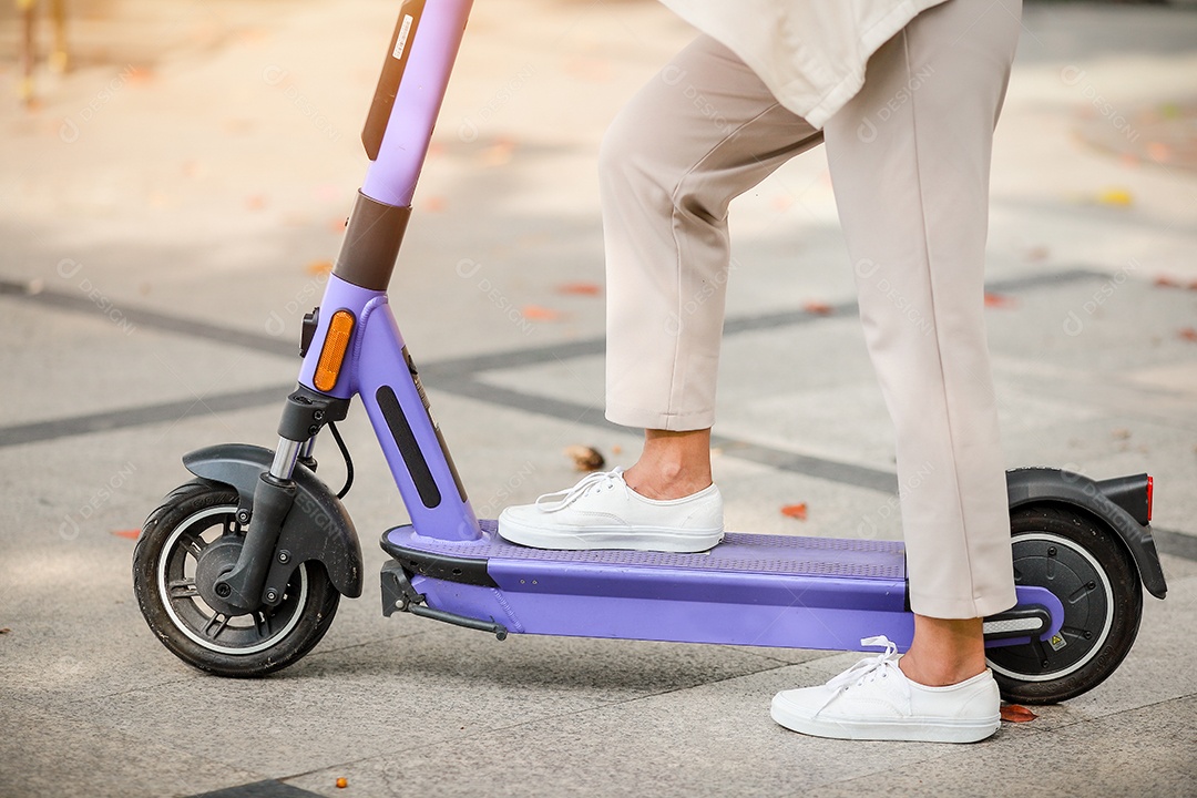 Senhora elegante de terno anda de scooter elétrica