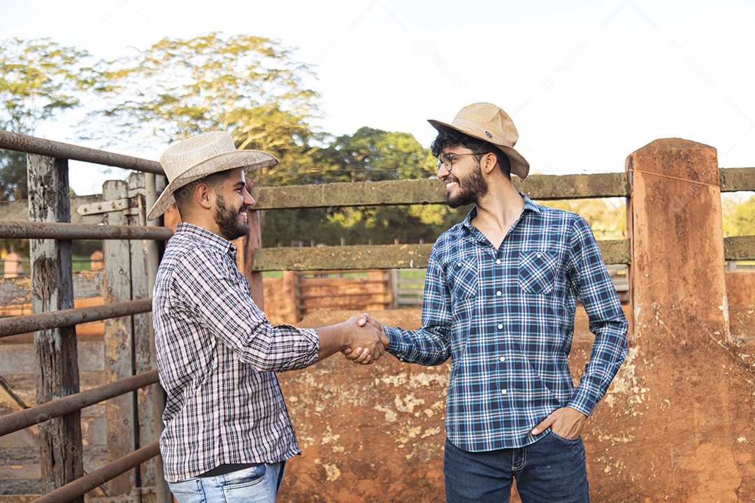 Homens agricultores fechando acordos sobre uma fazenda