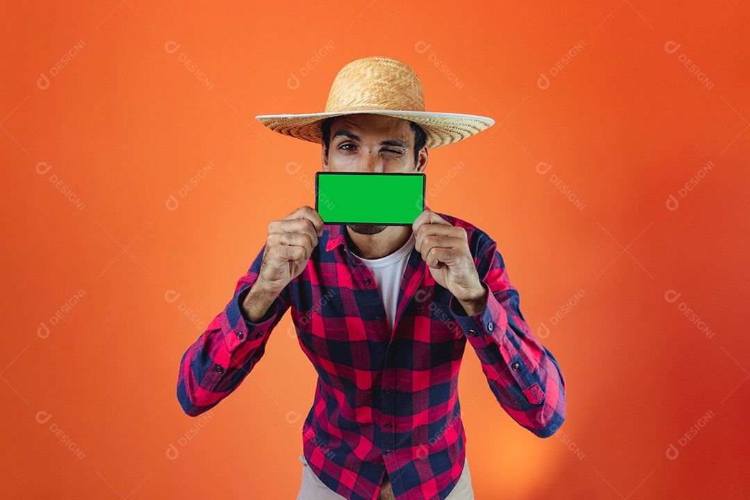 Festa Junina. Homem negro com roupa apontando isolado em fundo laranja.
