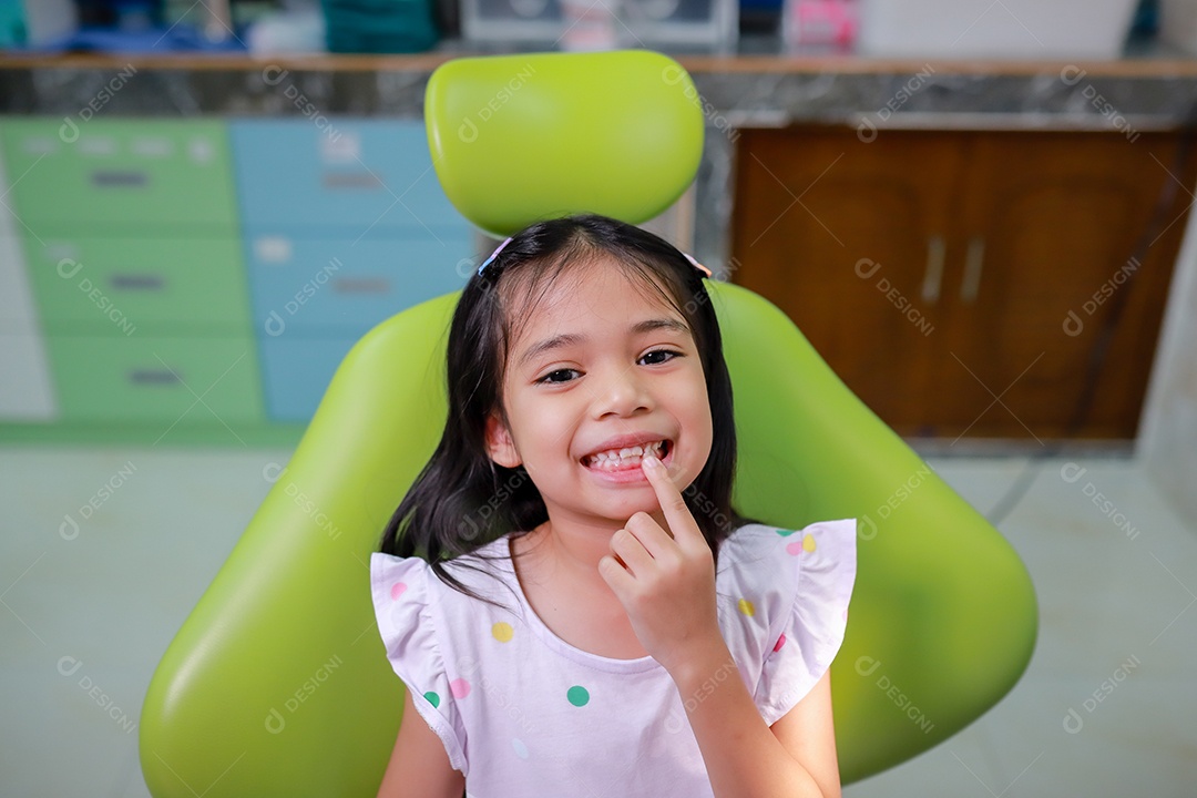 Esta linda garota está se preparando para sua consulta odontológica regular no check-up do consultório do dentista.