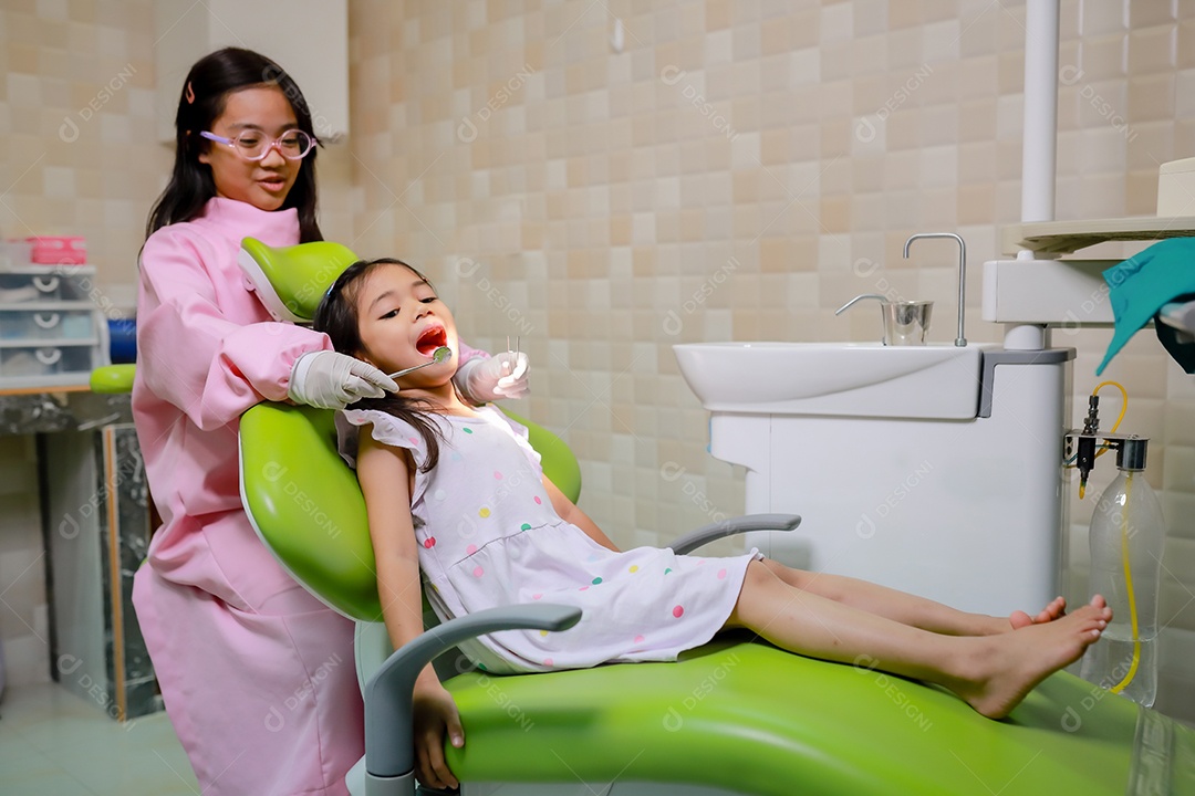 Esta linda garota está se preparando para sua consulta odontológica regular no check-up do consultório do dentista.