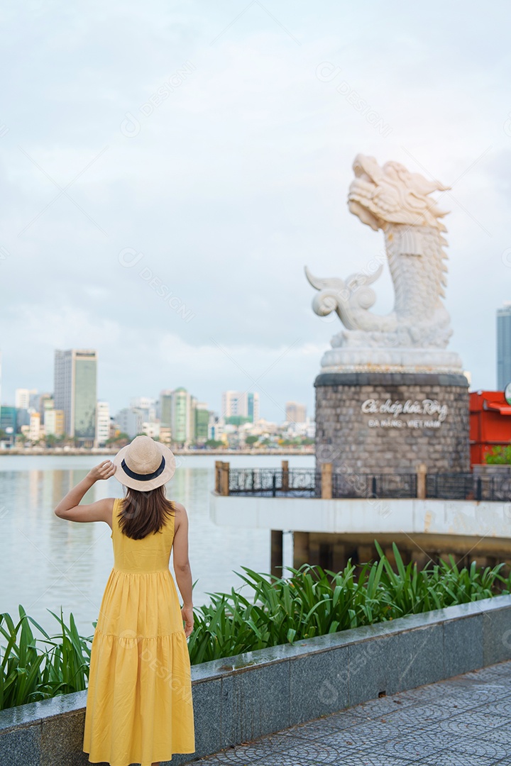 Mulher Viajante com vestido amarelo visitando a cidade de Da Nang