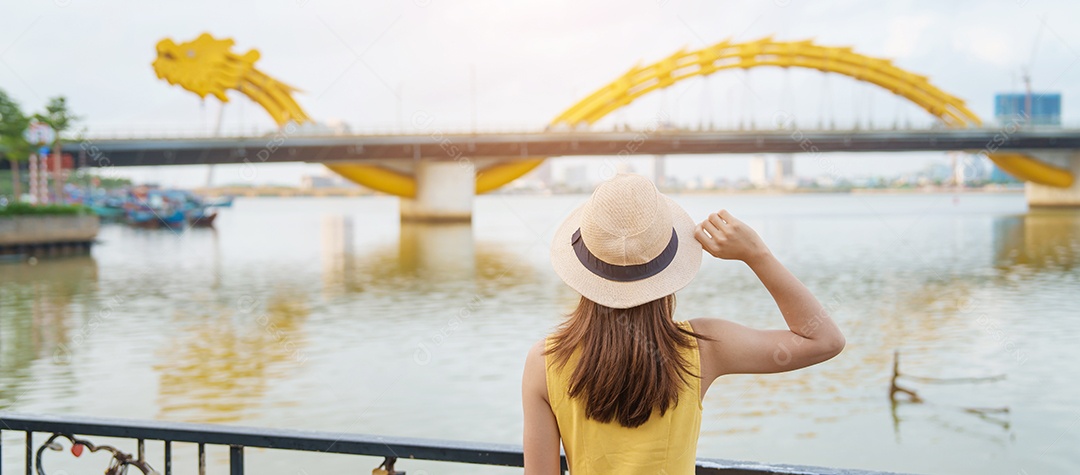 Mulher Viajante com vestido amarelo visitando Da Nang.