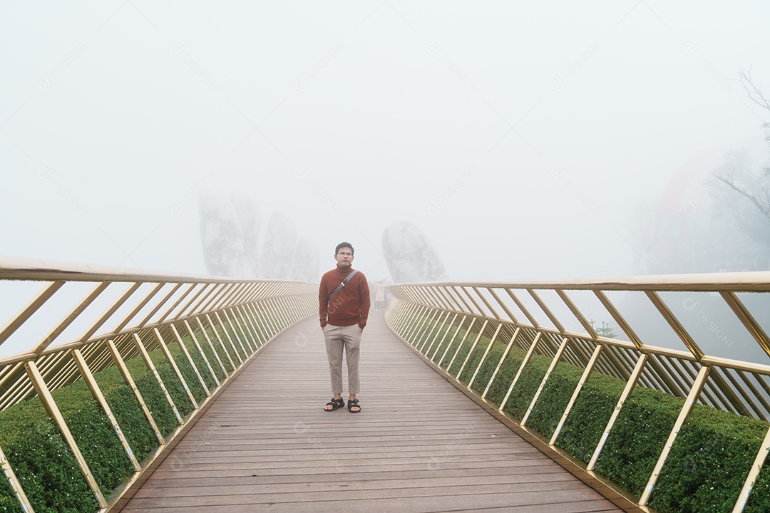 homem Viajante passeando Ponte dourada no topo das colinas Ba Na. Marco e popular.