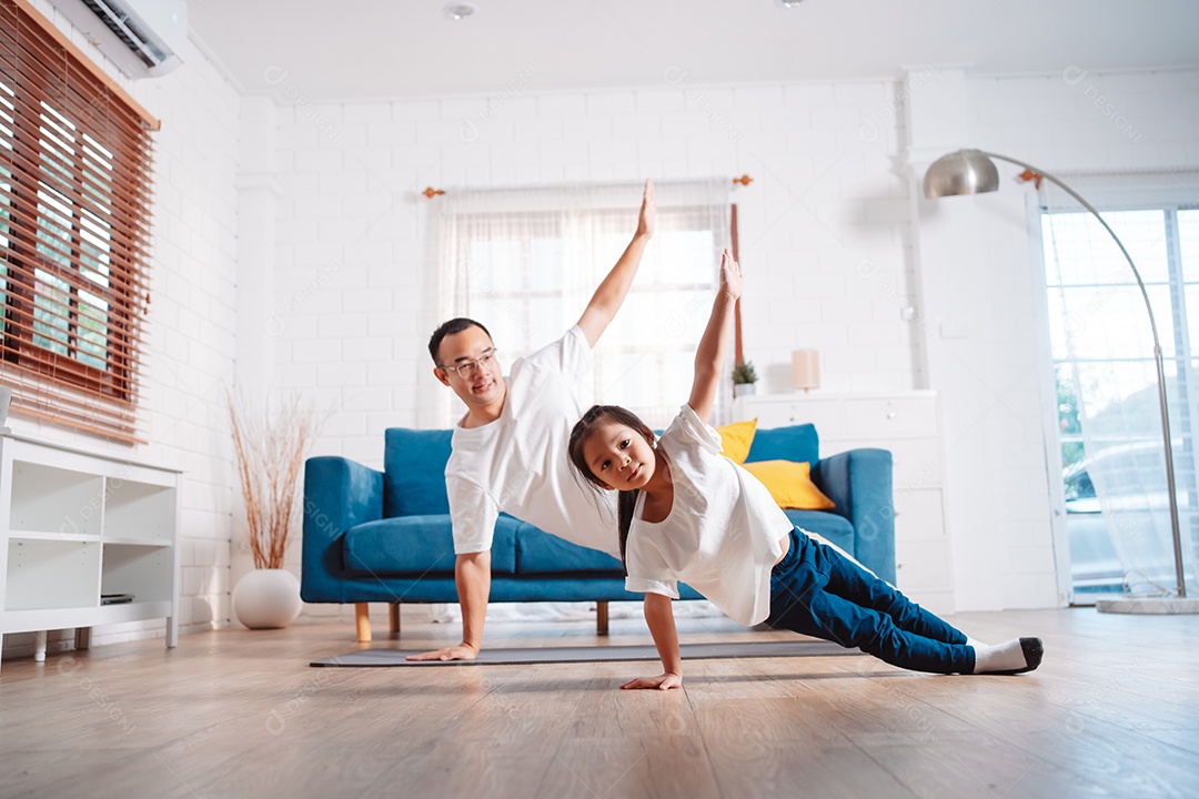 Pai e filha se exercitando juntos e felizes em casa.
