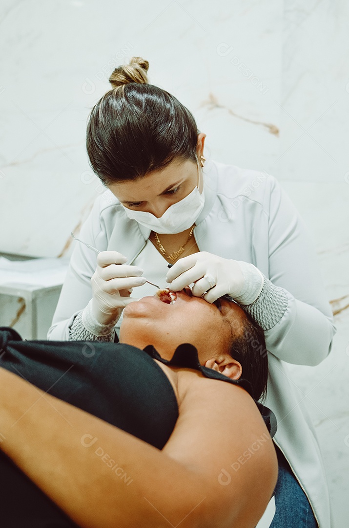 Dentista no consultório com paciente