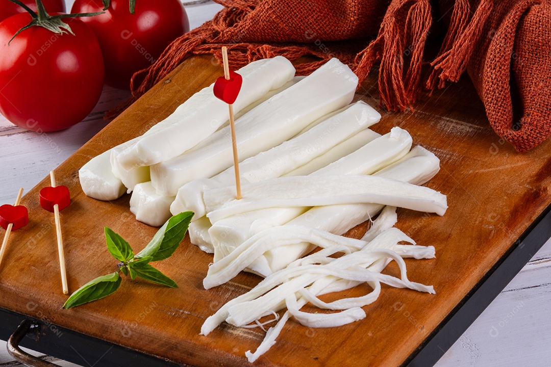 Palitos de mussarela de búfala e tomate vermelho na mesa branca