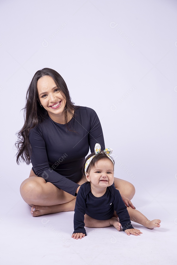 Linda mulher jovem com body preto sorridente segurando filha bebê