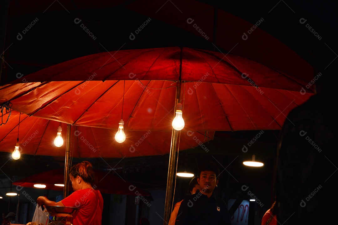 Guarda-sol vermelho e luzes a noite