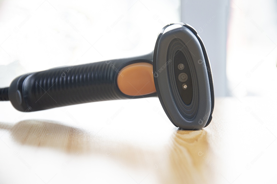 Barcode scanner placed on a brown wooden floor