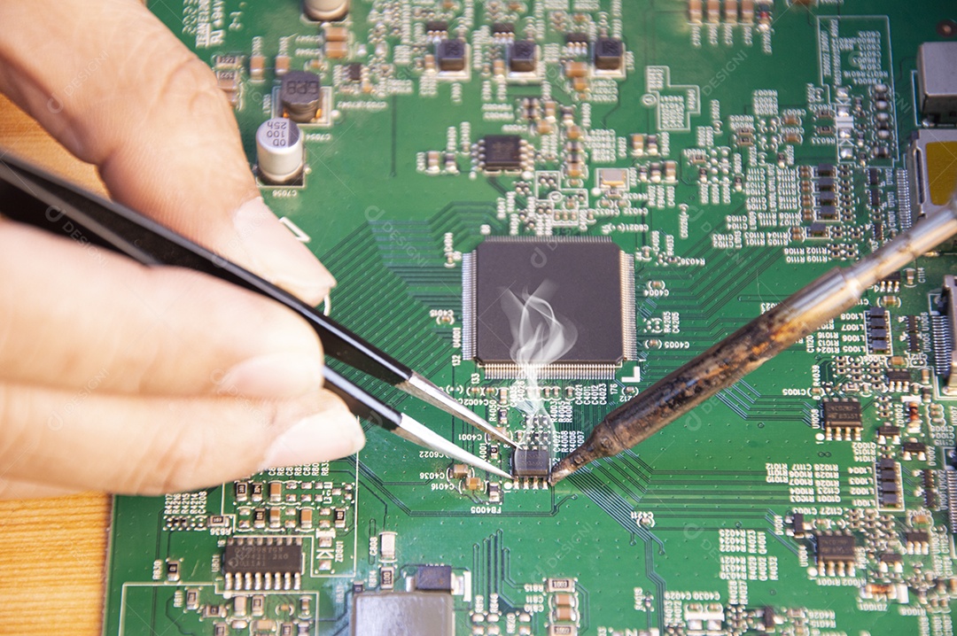 Vista superior de um técnico soldando placa mãe