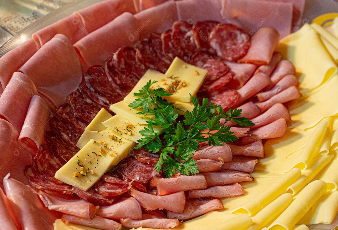 Café da manhã farto servido com bolos, tortas, geléias, doces, queijos, presunto, café, leite.