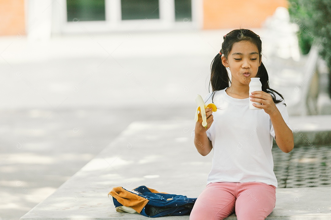 Garotinha sentada comendo lanche saudável