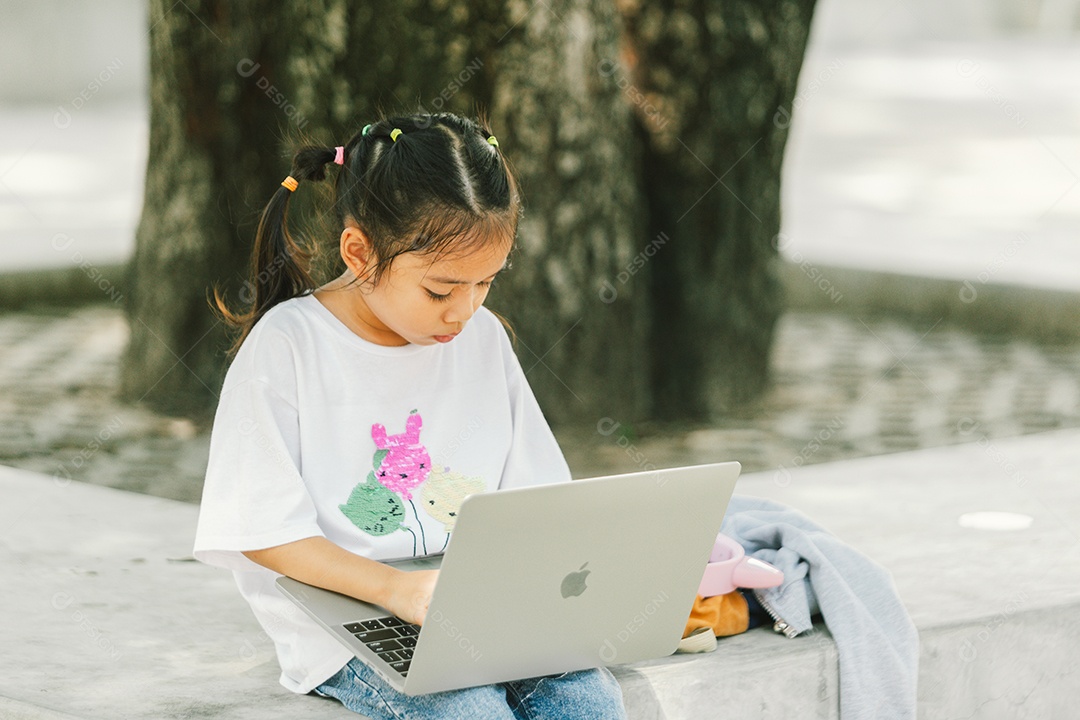 Garotinha sentada usando computador