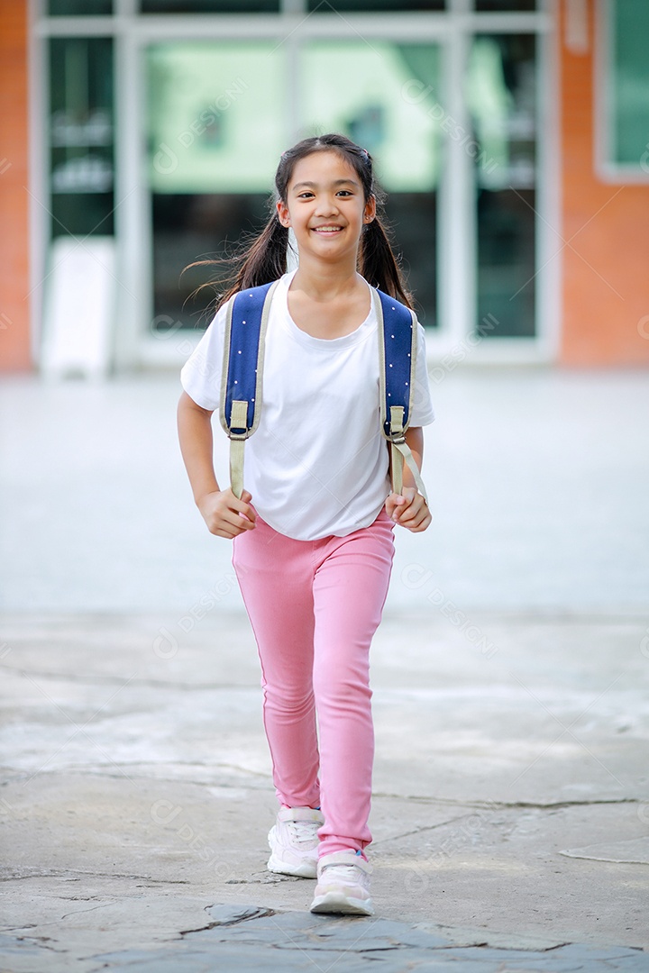 Criança menina asiática com uma mochila indo para a escola com diversão.