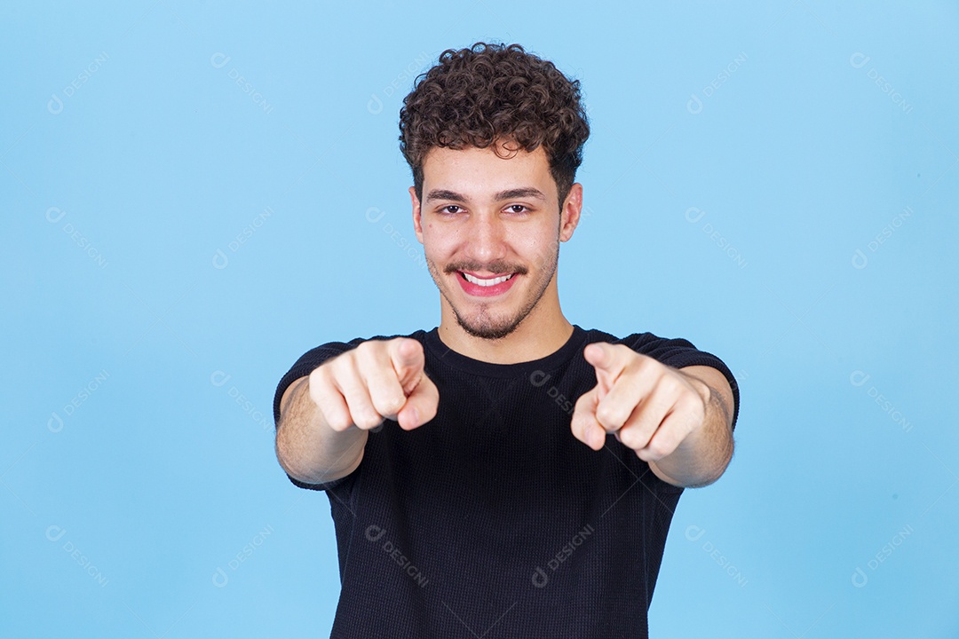 Homem jovem sorridente apontando dedo para frente
