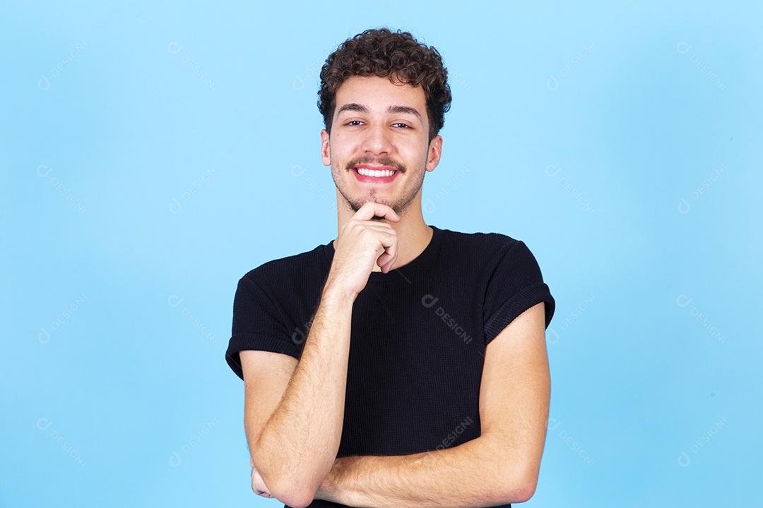 Homem jovem sorridente com a mão no queixo