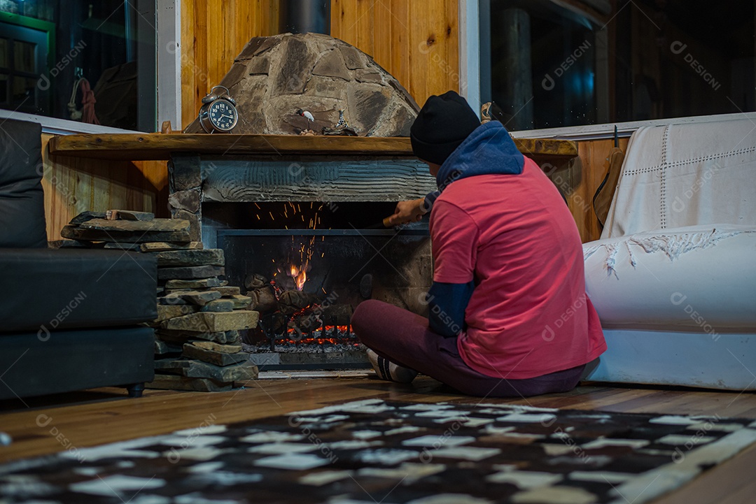 Homem esquentando na lareira