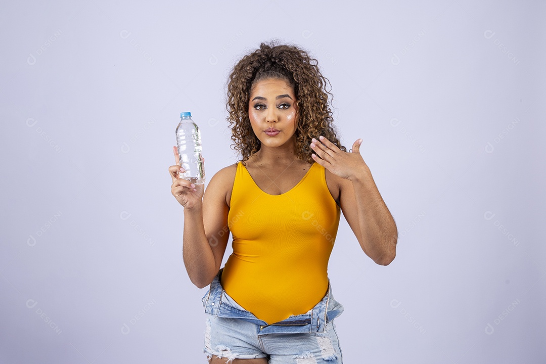 Linda mulher com maiô amarelo segurando garrafa de água