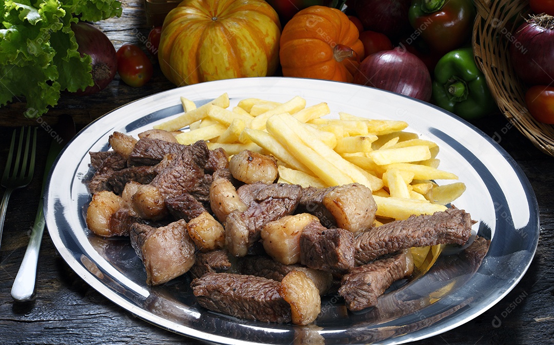 Picanha e batata frita em um prato sobre mesa de madeira