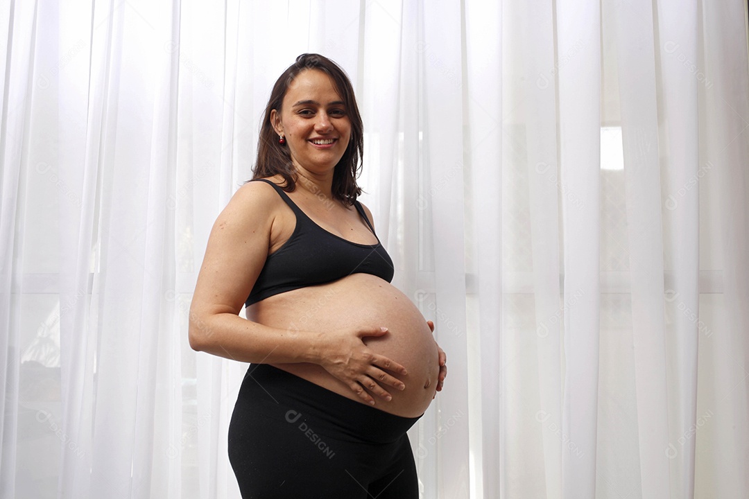 Linda mulher grávida com mãos na barriga