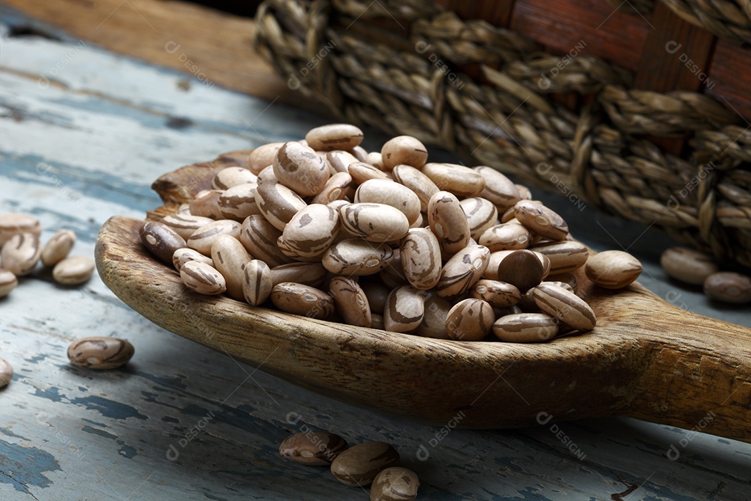 Grãos de feijão sobre colher de madeira