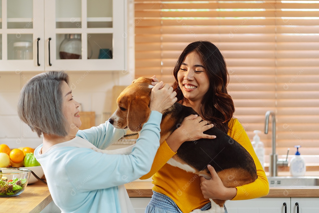 Mulher asiática sênior e filha desfrutando de seu animal de estimação em casa