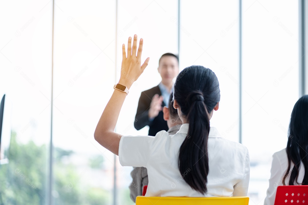 Pessoa de negócios levantando a mão durante o seminário.