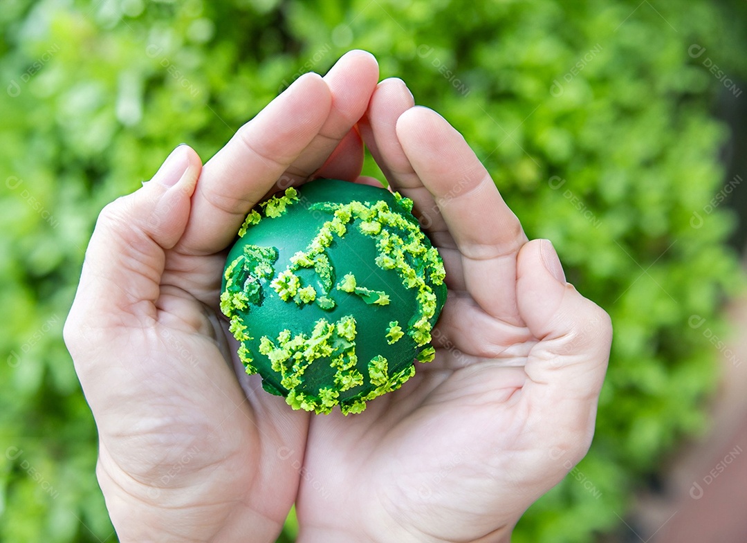 Planeta Terra nas mãos e folhas verdes
