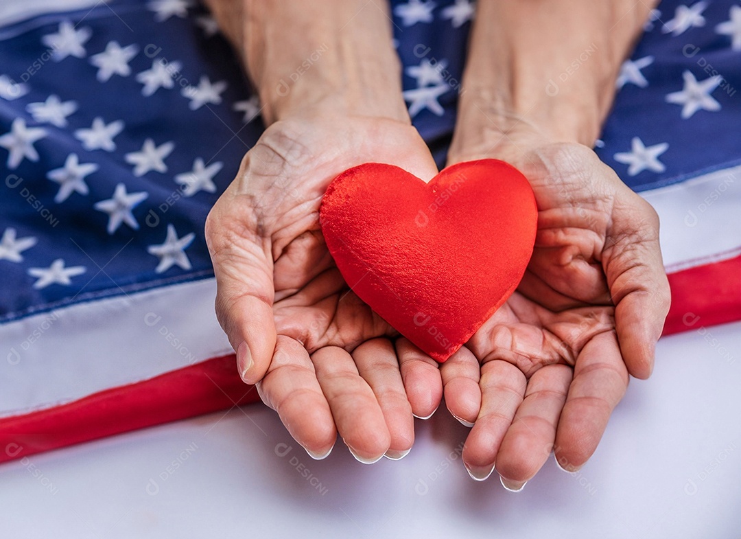 Mãos segurando um coração vermelho
