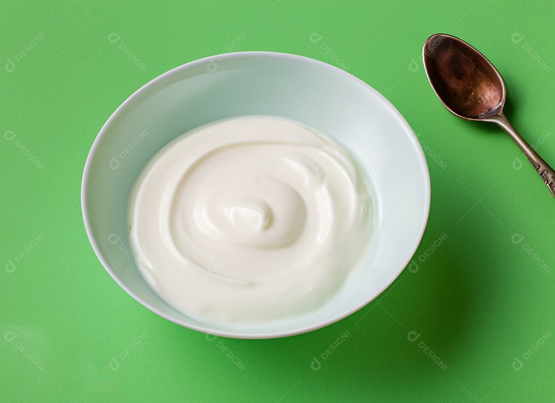 Iogurte em uma tigela no fundo verde